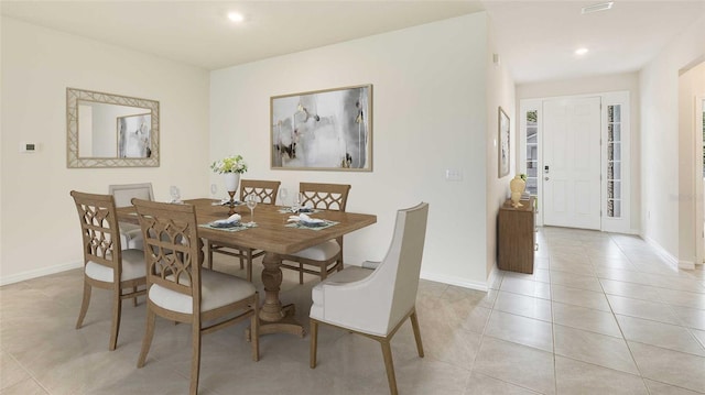 dining space featuring light tile patterned flooring