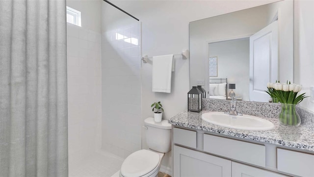 bathroom with walk in shower, vanity, and toilet