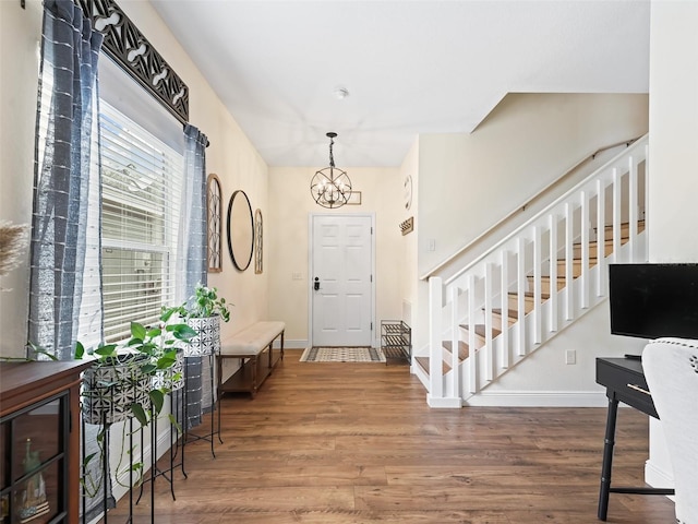 entryway with a chandelier and hardwood / wood-style flooring