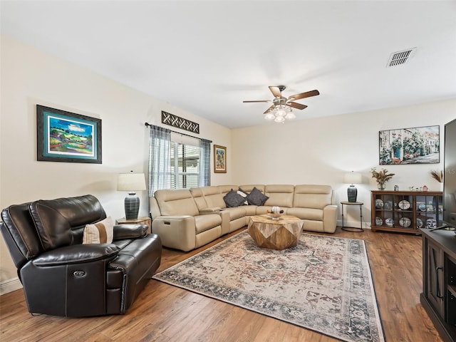 living room with hardwood / wood-style floors and ceiling fan