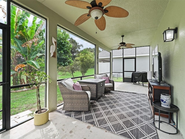 sunroom / solarium featuring ceiling fan and a healthy amount of sunlight