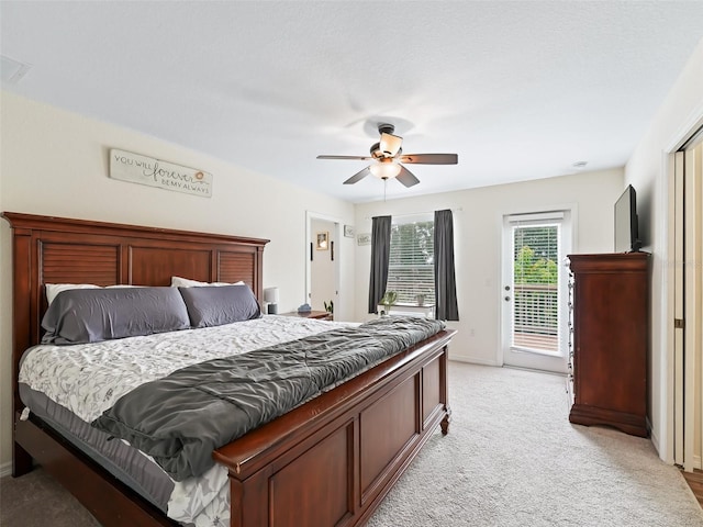 bedroom with access to exterior, ceiling fan, and light carpet