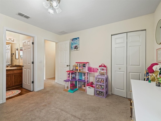 game room featuring light colored carpet, ceiling fan, and sink