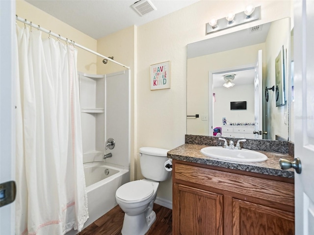 full bathroom featuring shower / bath combination with curtain, vanity, hardwood / wood-style flooring, and toilet