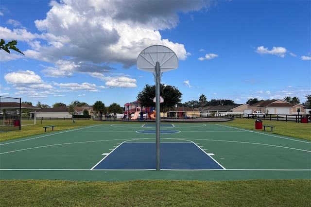 view of sport court with a yard and a playground