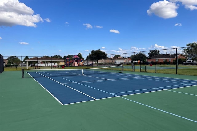 view of tennis court with a playground and basketball hoop