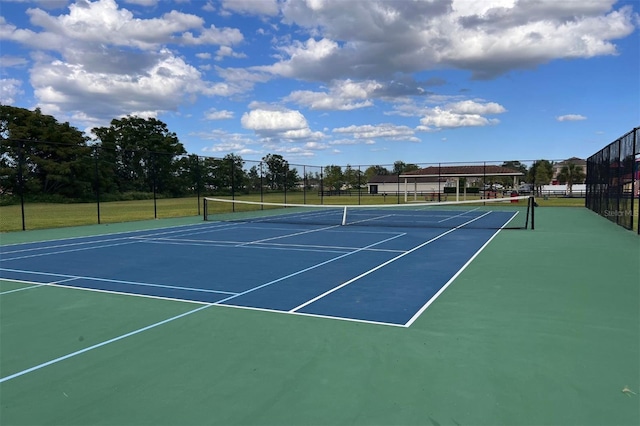 view of tennis court with basketball hoop