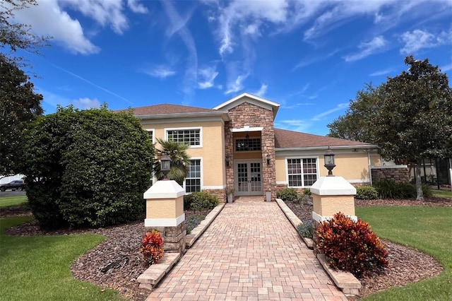 view of front facade featuring a front yard and french doors