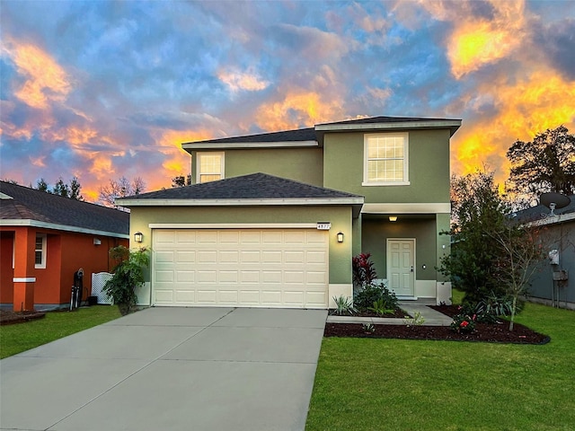 view of front property with a garage and a lawn