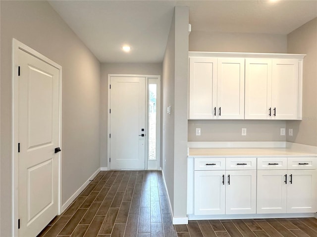 interior space featuring baseboards and wood tiled floor