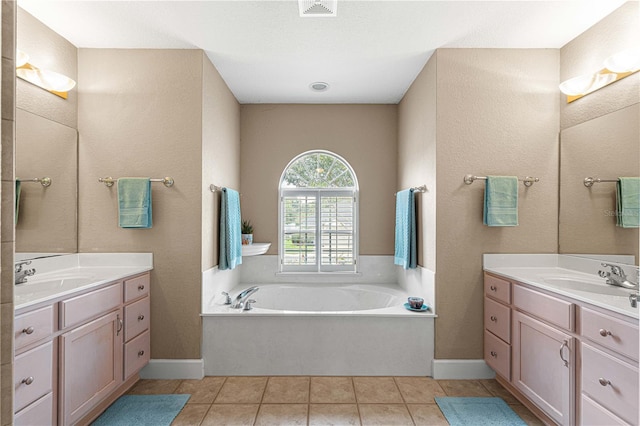 bathroom with vanity, tile patterned floors, a textured ceiling, and a washtub