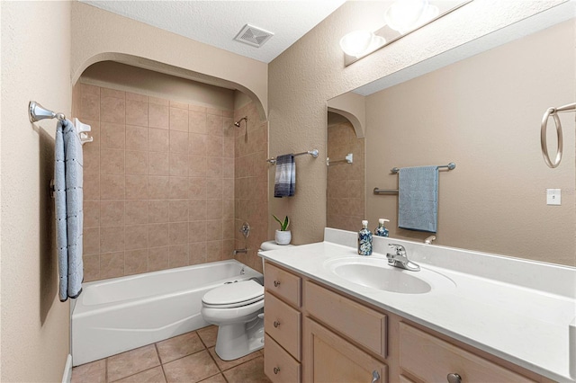 full bath featuring shower / washtub combination, vanity, tile patterned flooring, visible vents, and toilet