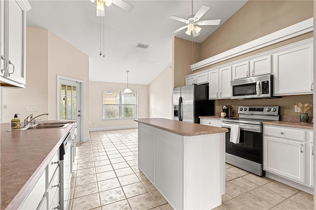 kitchen with high vaulted ceiling, stainless steel appliances, and white cabinetry