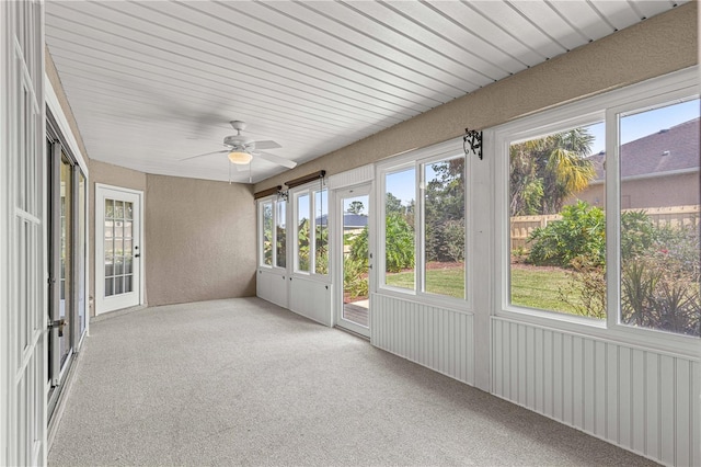 unfurnished sunroom with ceiling fan