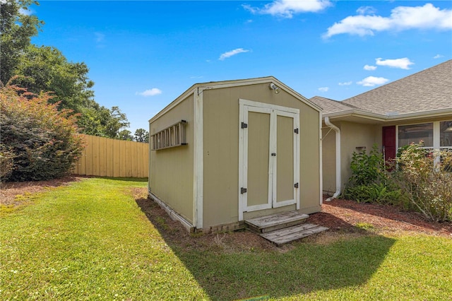 view of outbuilding featuring a yard