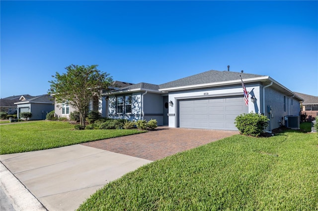 ranch-style house featuring a front yard, a garage, and central AC