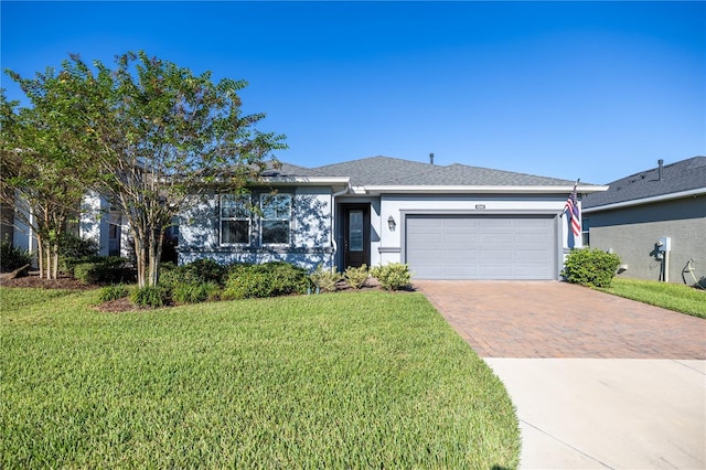 ranch-style home with a garage and a front lawn