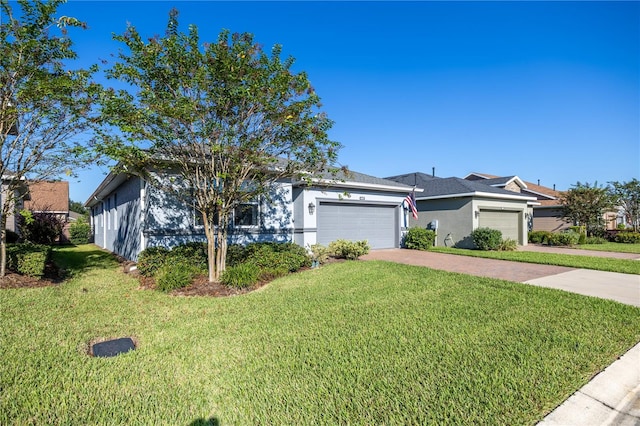 ranch-style house featuring a garage and a front lawn