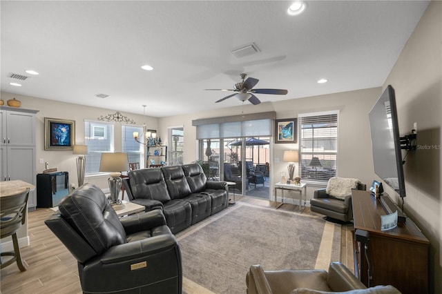 living room featuring light wood-type flooring and ceiling fan