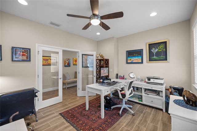 home office with light wood-type flooring, ceiling fan, and french doors