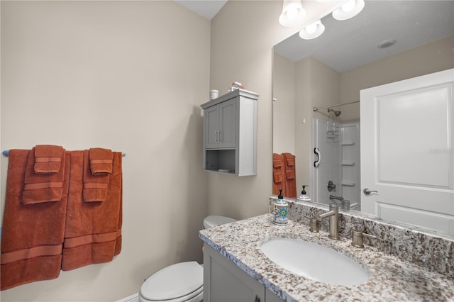 bathroom featuring walk in shower, vanity, and toilet