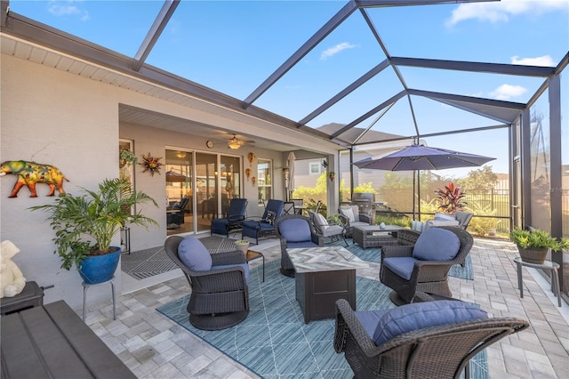 view of patio / terrace featuring ceiling fan, an outdoor hangout area, and a lanai