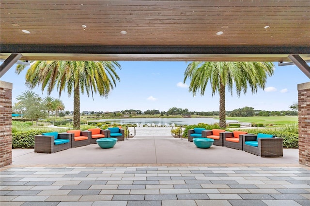 view of patio / terrace featuring a water view and an outdoor living space