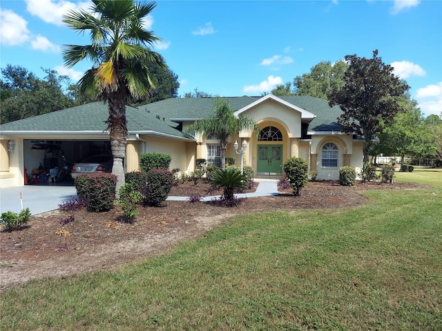 ranch-style house featuring a front yard and a garage