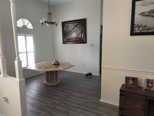 dining area with a chandelier and dark wood-type flooring