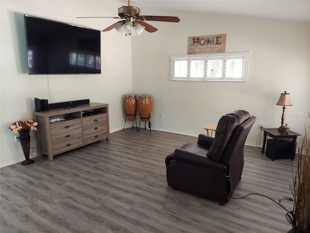 living room featuring vaulted ceiling, ceiling fan, and dark wood-type flooring