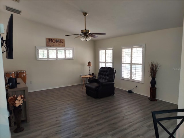 living area featuring dark wood-type flooring and ceiling fan