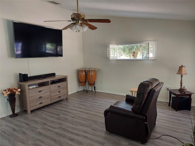 living room featuring lofted ceiling, ceiling fan, and hardwood / wood-style flooring