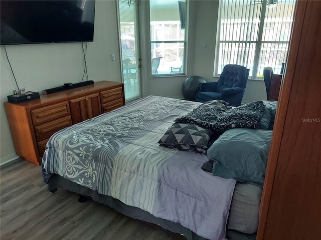 bedroom featuring access to outside and hardwood / wood-style floors