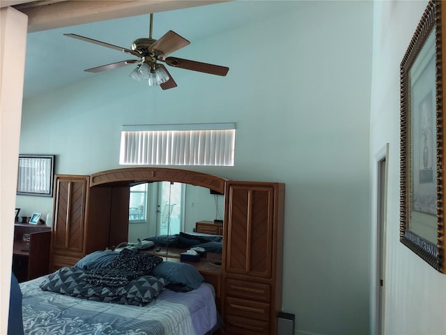 bedroom featuring ceiling fan and high vaulted ceiling