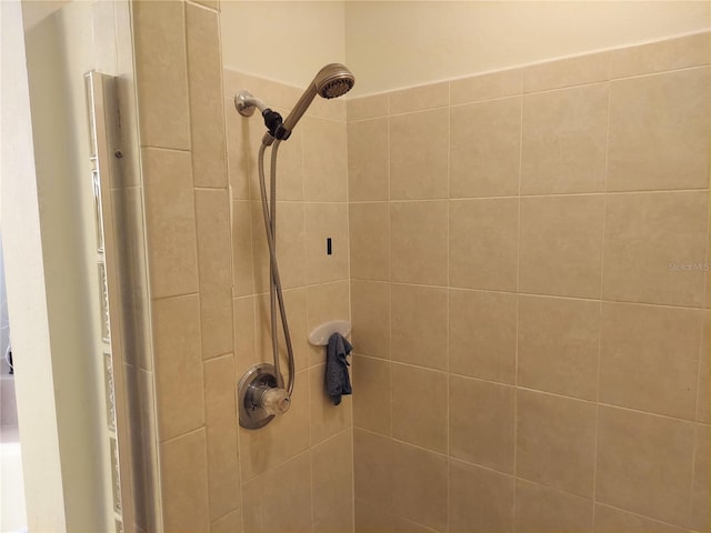 interior details with a tile shower