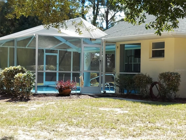 rear view of house featuring a yard