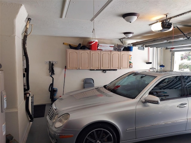 garage featuring a garage door opener and water heater