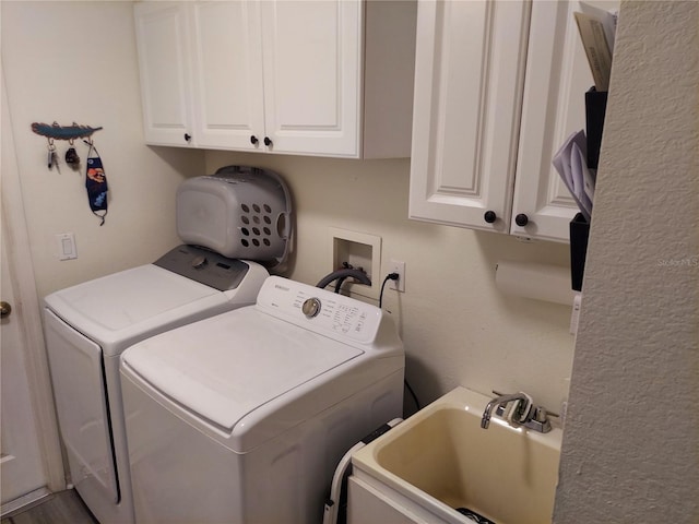 laundry room featuring cabinets, washer and dryer, and sink