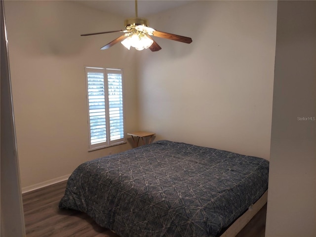 bedroom with ceiling fan and dark wood-type flooring