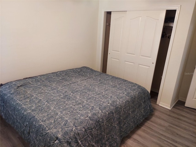 bedroom featuring a closet and dark hardwood / wood-style flooring