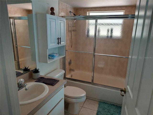 full bathroom with vanity, combined bath / shower with glass door, toilet, and tile patterned floors