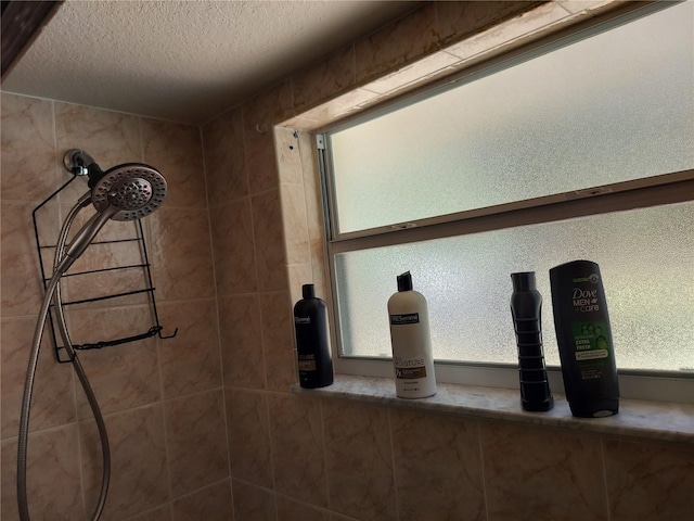 bathroom with a tile shower