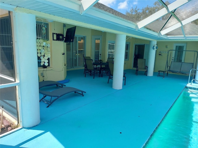 view of patio with glass enclosure