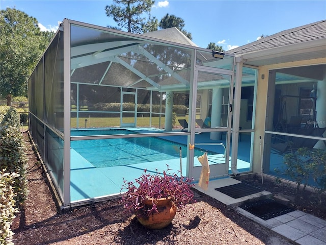 view of pool featuring a patio and glass enclosure