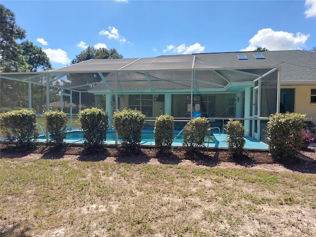 rear view of property with a lanai