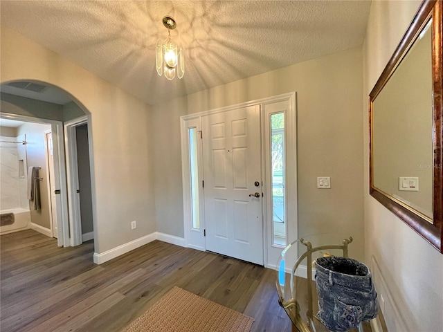 entrance foyer featuring a textured ceiling and dark hardwood / wood-style flooring