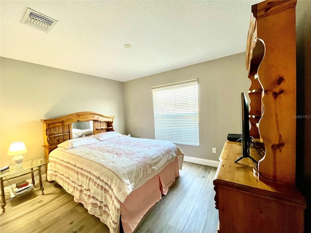 bedroom with hardwood / wood-style flooring