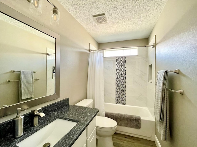 full bathroom with vanity, toilet, shower / bath combo, a textured ceiling, and hardwood / wood-style floors