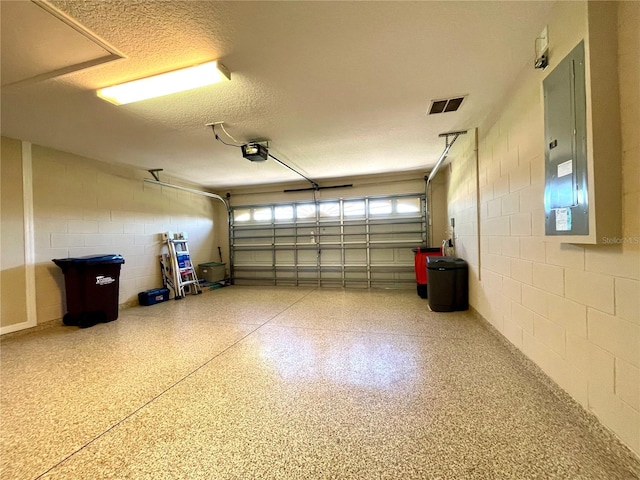 garage with electric panel and a garage door opener