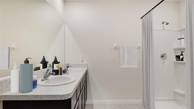 bathroom with walk in shower, vanity, and tile patterned flooring